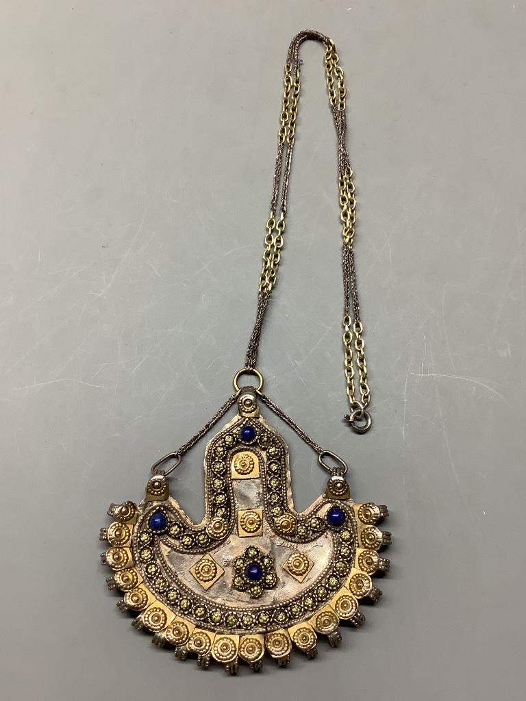 An Afghan? parcel gilt white metal and cabochon lapis lazuli demi-lune shaped pendant necklace